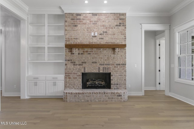 111 Grand Oak Blvd, Clinton, MS 39056 - unfurnished living room featuring light wood finished floors, baseboards, a brick fireplace, crown molding, and recessed lighting