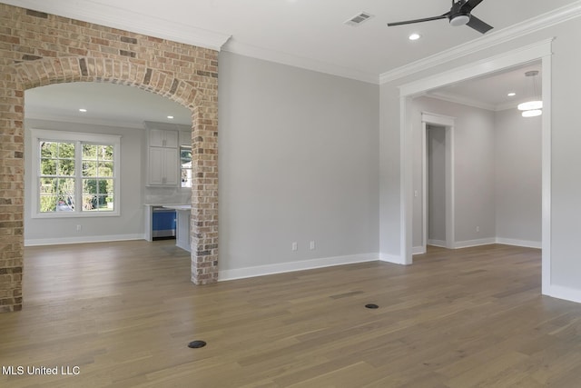 111 Grand Oak Blvd, Clinton, MS 39056 - unfurnished living room with ceiling fan, wood finished floors, baseboards, arched walkways, and recessed lighting