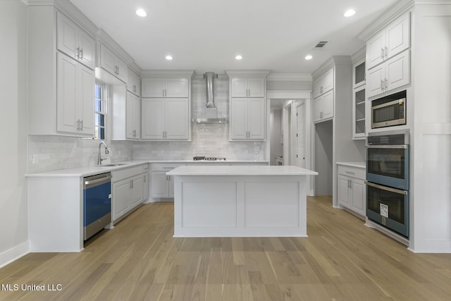 111 Grand Oak Blvd, Clinton, MS 39056 - kitchen with wall chimney exhaust hood, dishwasher, double oven, a sink, and backsplash