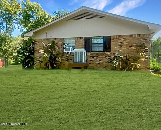 back of property featuring central AC and a lawn