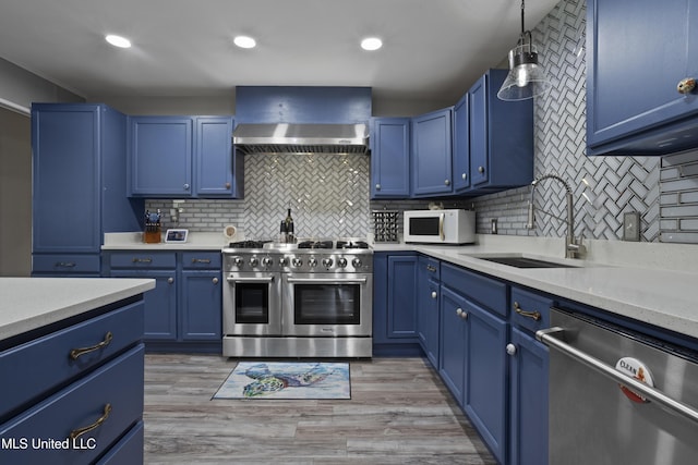 56 53rd St, Gulfport, MS 39507 - kitchen featuring dishwasher, range with two ovens, blue cabinets, white microwave, and recessed lighting