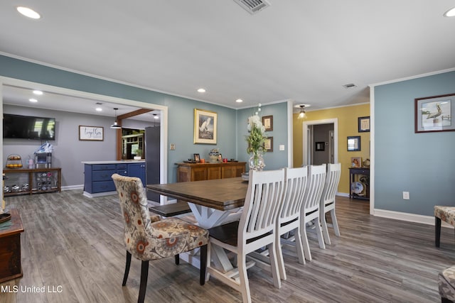 56 53rd St, Gulfport, MS 39507 - dining area featuring crown molding, wood finished floors, and recessed lighting