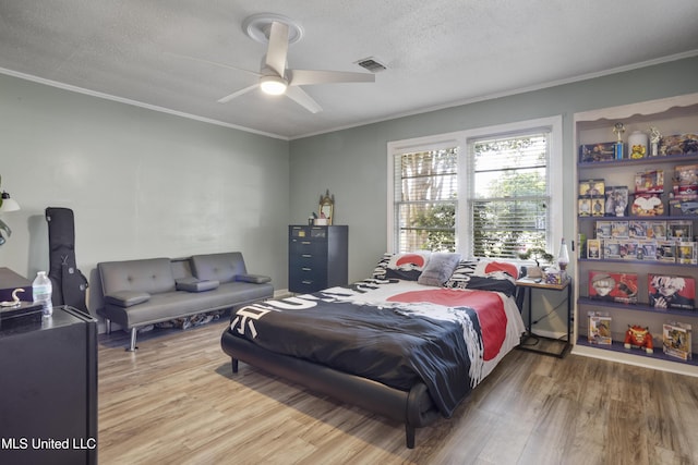 56 53rd St, Gulfport, MS 39507 - bedroom featuring crown molding, wood finished floors, a textured ceiling, and a ceiling fan