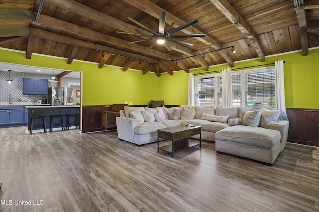 56 53rd St, Gulfport, MS 39507 - living area with wooden ceiling, a wainscoted wall, wood finished floors, ceiling fan, and wood walls