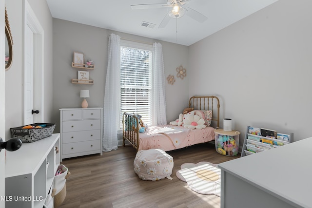 bedroom featuring ceiling fan, visible vents, and wood finished floors