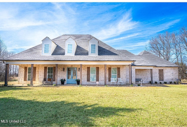 view of front of property featuring a shingled roof, french doors, brick siding, and a front lawn