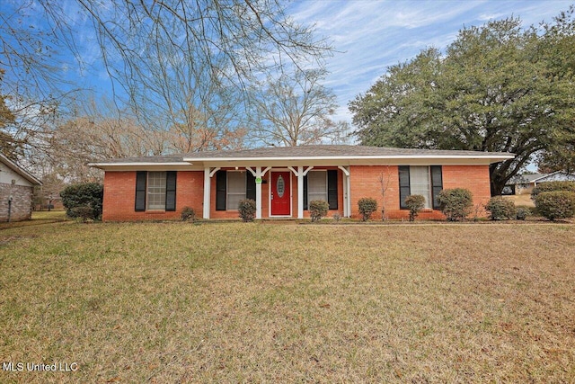 ranch-style house featuring brick siding and a front yard