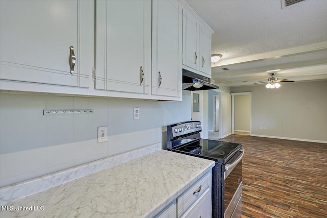 kitchen with electric stove, dark wood-style flooring, a textured ceiling, under cabinet range hood, and white cabinetry