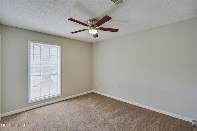 unfurnished room featuring a textured ceiling, carpet floors, a ceiling fan, and baseboards