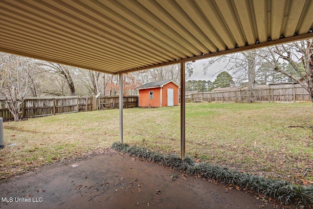 view of yard with an outbuilding, a fenced backyard, and a storage shed