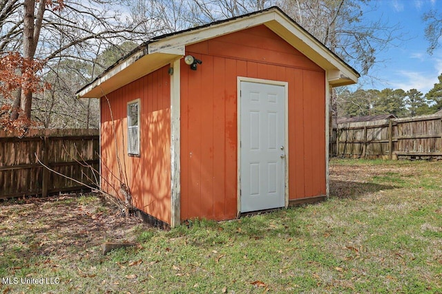 view of shed featuring fence