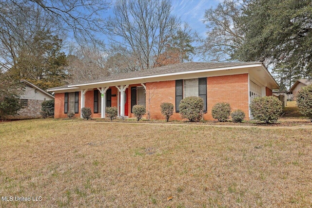 single story home with a front lawn, brick siding, and an attached garage