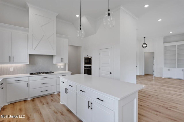 420 Lennon Ln, Brandon, MS 39047 - kitchen with crown molding, light wood finished floors, light countertops, stainless steel appliances, and backsplash