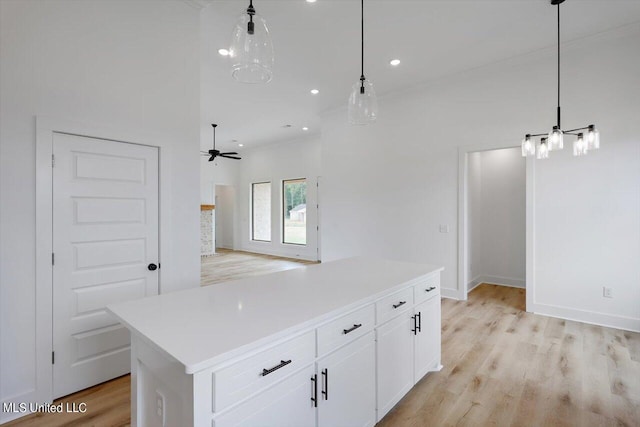 420 Lennon Ln, Brandon, MS 39047 - kitchen featuring pendant lighting, a center island, light countertops, light wood finished floors, and white cabinetry