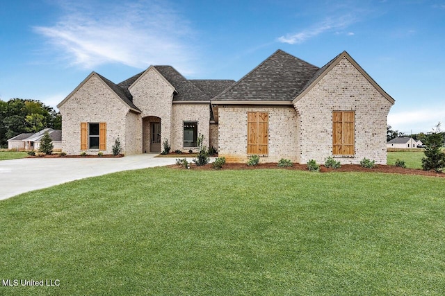 420 Lennon Ln, Brandon, MS 39047 - french country inspired facade with concrete driveway, brick siding, an attached garage, and a front yard