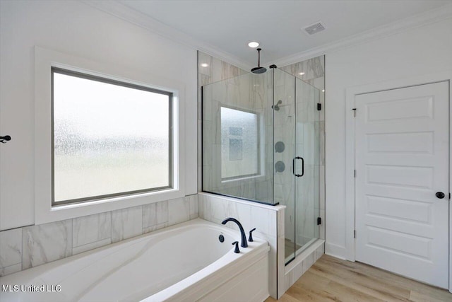 420 Lennon Ln, Brandon, MS 39047 - full bathroom featuring visible vents, crown molding, a garden tub, wood finished floors, and a shower stall