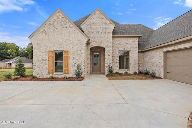 420 Lennon Ln, Brandon, MS 39047 - french country style house with a garage, a shingled roof, and brick siding