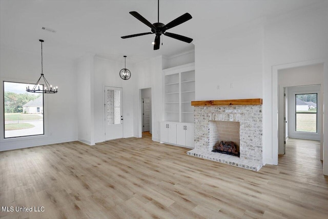420 Lennon Ln, Brandon, MS 39047 - unfurnished living room with built in shelves, a brick fireplace, wood finished floors, and visible vents