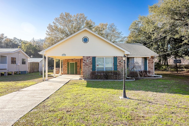 view of front facade with a front yard and a carport