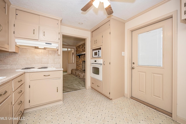 kitchen with a textured ceiling, white appliances, ceiling fan, and crown molding