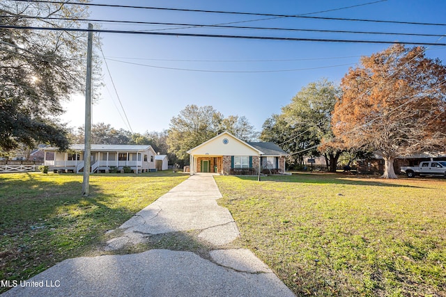 view of front of home with a porch and a front lawn