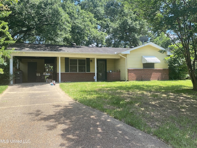 115 Richland St, Richland, MS 39218 - view of front of house with driveway, brick siding, a front yard, and a carport