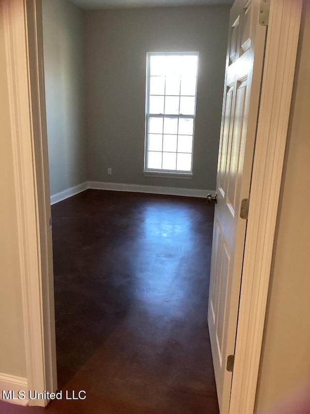 empty room with dark hardwood / wood-style flooring