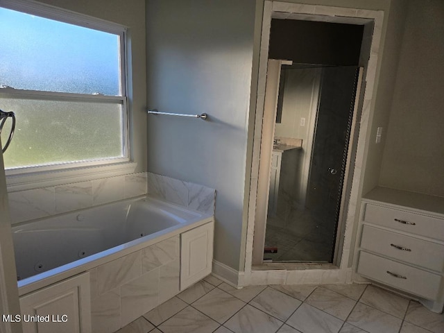 bathroom with shower with separate bathtub and plenty of natural light