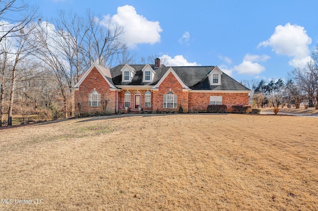 view of front of house featuring brick siding and a front lawn