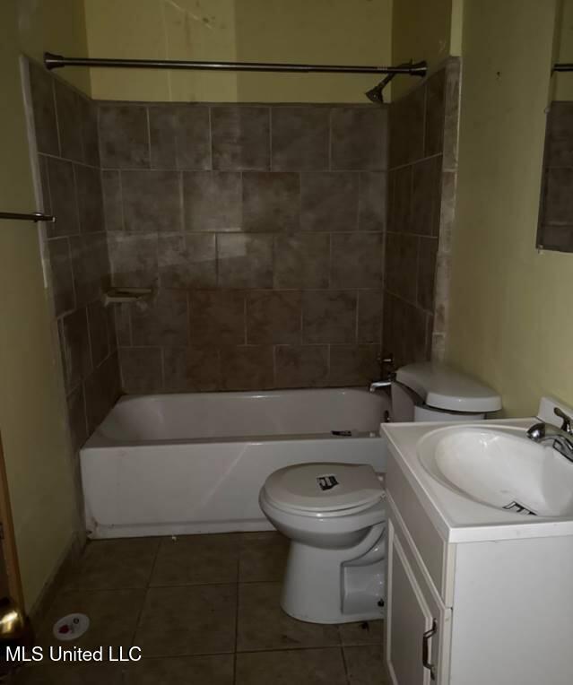 230 Hillside Dr, Vicksburg, MS 39180 - bathroom with tile patterned flooring,  shower combination, toilet, and vanity