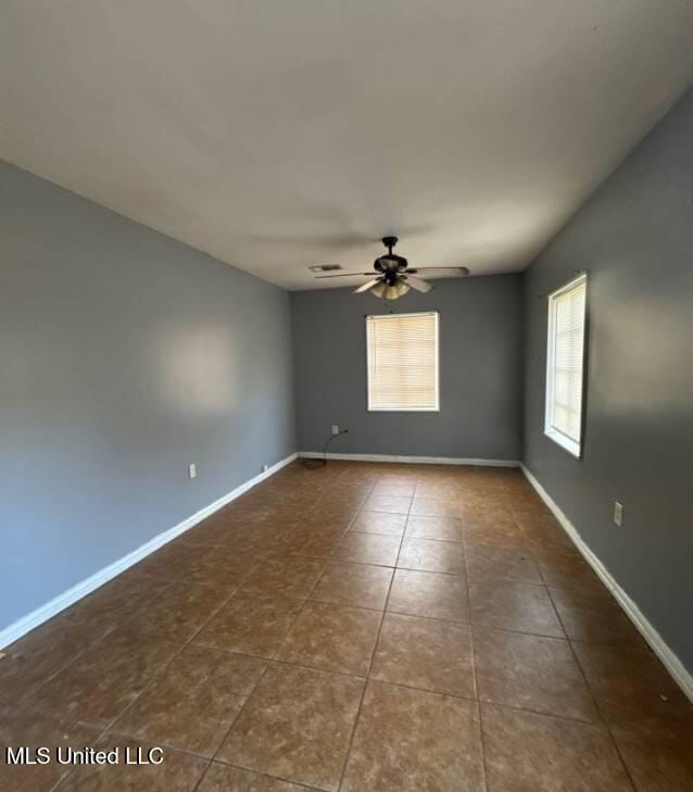 230 Hillside Dr, Vicksburg, MS 39180 - tiled spare room featuring visible vents, a ceiling fan, and baseboards