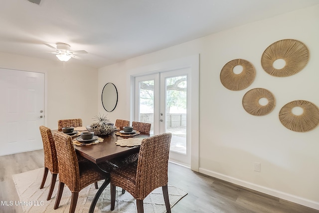 dining room featuring baseboards, a ceiling fan, french doors, and light wood finished floors