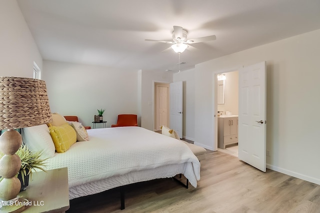 bedroom with light wood-type flooring, baseboards, ceiling fan, and connected bathroom
