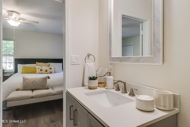 ensuite bathroom with ensuite bath, a ceiling fan, vanity, and wood finished floors