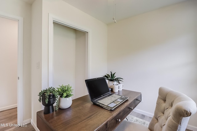 office area featuring baseboards and wood finished floors