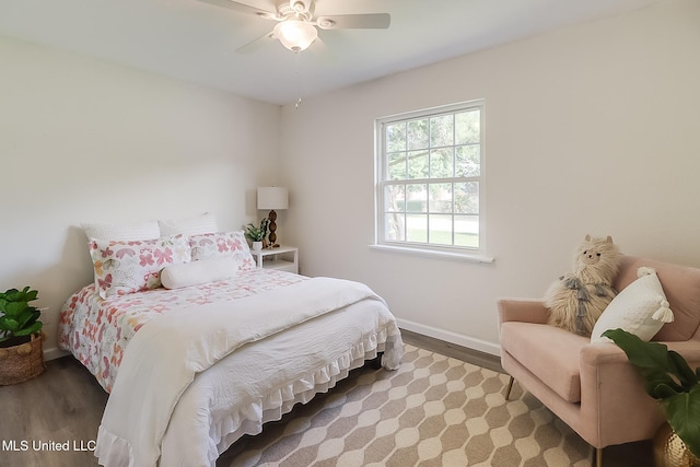 bedroom with wood finished floors, baseboards, and ceiling fan