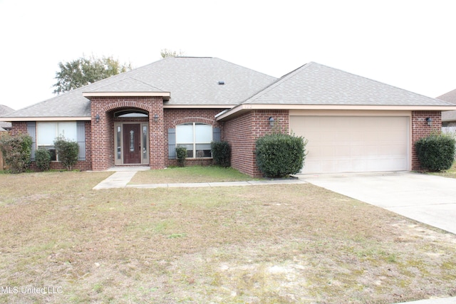 ranch-style home with a garage and a front lawn