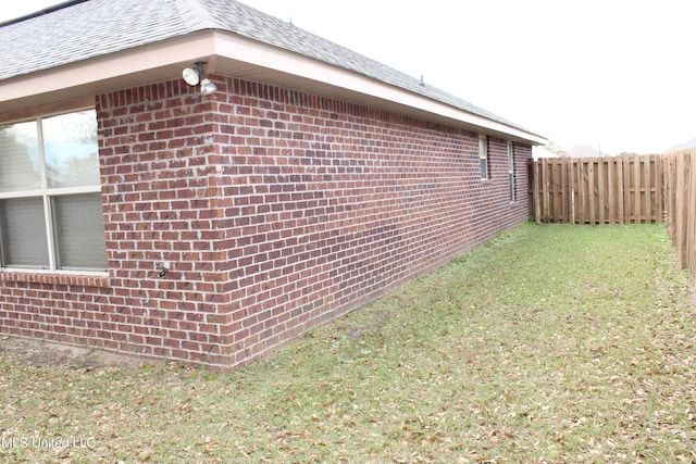 view of property exterior with a lawn