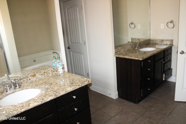 bathroom featuring vanity, tile patterned flooring, and a washtub