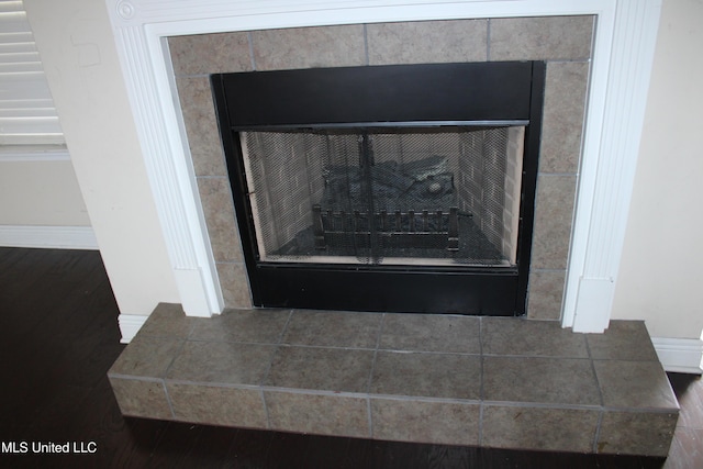 details featuring hardwood / wood-style floors and a fireplace