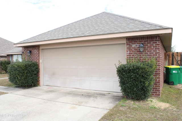 view of property exterior featuring a garage and an outbuilding