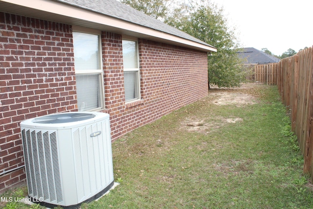 exterior space with a yard and central AC unit