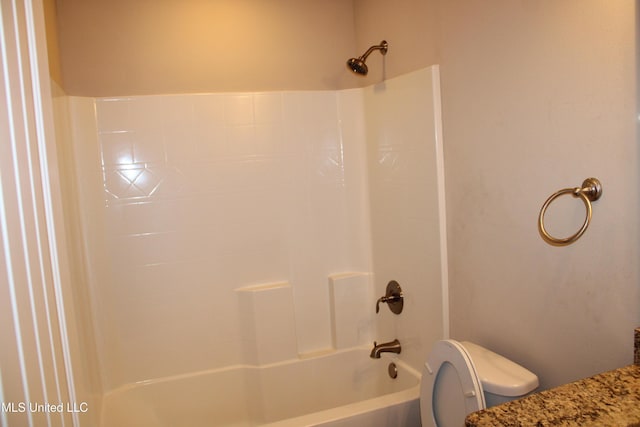 bathroom with tub / shower combination and toilet