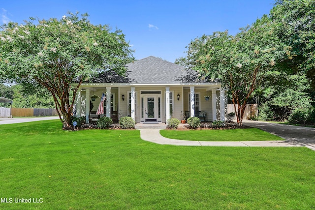 view of front of property with covered porch and a front yard