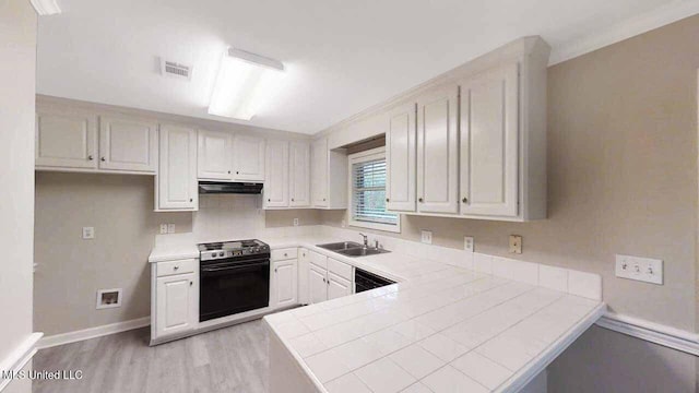594 Acorn Ln, Brandon, MS 39047 - kitchen featuring stove, range hood, light wood finished floors, tile countertops, and a peninsula