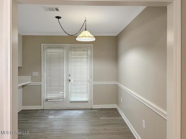 594 Acorn Ln, Brandon, MS 39047 - unfurnished dining area featuring ornamental molding, wood finished floors, and plenty of natural light