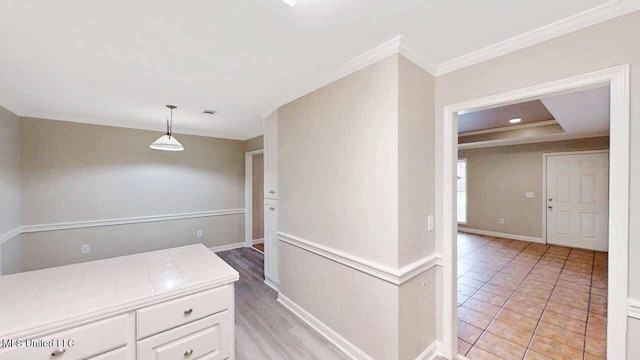 594 Acorn Ln, Brandon, MS 39047 - kitchen featuring tile counters, white cabinetry, ornamental molding, and decorative light fixtures