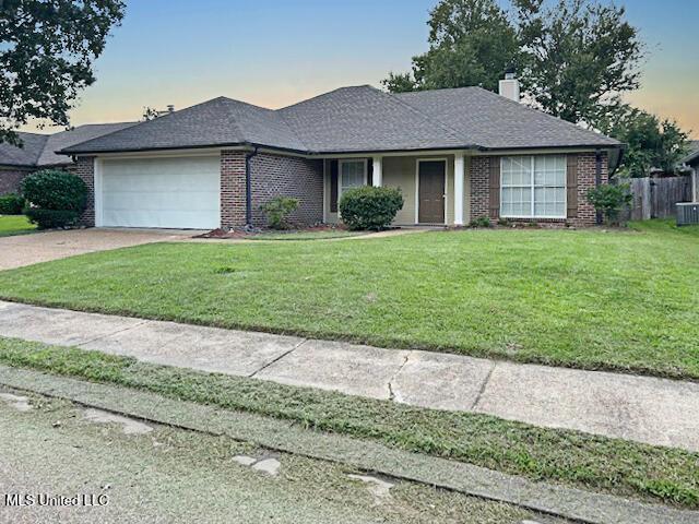 594 Acorn Ln, Brandon, MS 39047 - ranch-style home with brick siding, an attached garage, concrete driveway, and a chimney