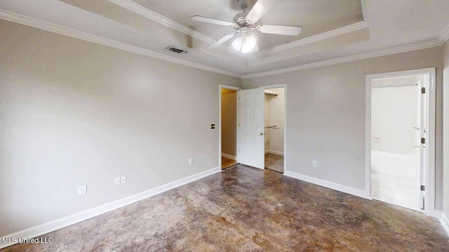 594 Acorn Ln, Brandon, MS 39047 - unfurnished bedroom with a raised ceiling, finished concrete floors, ornamental molding, connected bathroom, and a walk in closet