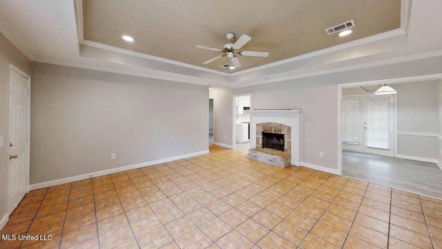 594 Acorn Ln, Brandon, MS 39047 - unfurnished living room with a raised ceiling, a ceiling fan, tile patterned flooring, a fireplace with raised hearth, and recessed lighting